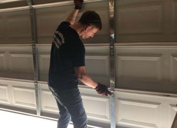 Employee installing garage door