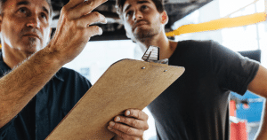 Blog 9 2 men talking with clipboard